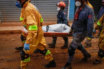(EDITORS NOTE: Image depicts death.) Firefighters remove a body from debris following a landslide caused by heavy rain and flooding in Barra do Sahy, Sao Paulo state, Brazil, on Friday, Feb. 24, 2023. Heavy rains inundated the Sao Paulo coast during the week of Carnival, causing flooding and landslides that left dozens dead and missing.  Photographer: Tuane Fernandes/Bloomberg via Getty Images