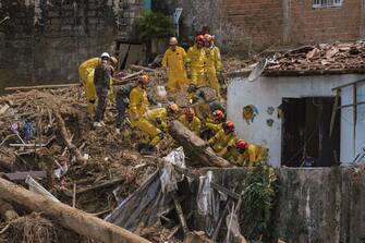 Firefighters search the rubble for missing residents following a landslide caused by heavy rain and flooding in Barra do Sahy, Sao Paulo state, Brazil, on Friday, Feb. 24, 2023. Heavy rains inundated the Sao Paulo coast during the week of Carnival, causing flooding and landslides that left dozens dead and missing.  Photographer: Tuane Fernandes/Bloomberg via Getty Images
