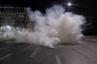 epa10501507 Riot police throws tear gas against protesters during a protest over Greece's deadliest train crash in front of Parliament in Athens, Greece, 03 March 2023. The death toll of the train collision that occurred on the Athens-Thessaloniki line has risen to 57, a Hellenic Police spokesperson confirmed on 02 March 2023. The collision between a passenger train traveling north and a freight train traveling south on the same line occurred on 28 February night.  EPA/GEORGE VITSARAS