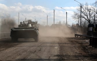 A Ukrainian armoured personnel carrier (APC) rides by a road outside Bakhmut, in the Donetsk region on March 3, 2023. (Photo by Anatolii Stepanov / AFP) (Photo by ANATOLII STEPANOV/AFP via Getty Images)