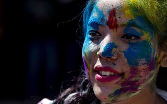 epa08280081 A young girl is covered in colored powder during Holi Festival celebrations in Kathmandu, Nepal, 09 March 2020. Holi, also known as the Festival of Colors, marks the beginning of spring and is celebrated all over Nepal and neighboring India.  EPA/NARENDRA SHRESTHA