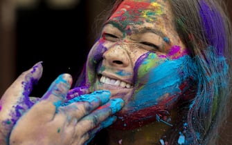 epa09102838 A Nepalese girl smeared with colors during celebrations of Holi Festival amidst Coronavirus restrictions in Kathmandu, Nepal, 28 March 2021. Holi, also known as the Festival of Colors, marks the beginning of spring and is celebrated all over Nepal and neighboring India. Nepal government restricted to celebrate the Holi festival by gathering crowd and organizing party due to the spread of the coronavirus COVID-19 disease.  EPA/NARENDRA SHRESTHA