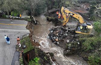 SOQUEL, CALIFORNIA - MARCH 10: In an aerial view, workers make emergency repairs to a road that was washed out heavy rains on March 10, 2023 in Soquel, California. An atmospheric river event brought high winds and heavy rains to Northern California that caused localized flooding and toppled trees. A second atmospheric event will hit Northern California by Monday or Tuesday. (Photo by Justin Sullivan/Getty Images)