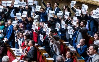FRANCE GOVERNMENT PENSION epa10526677 French Deputies of NUPES coalition (New Ecological and Social Union) show posters reading No to 64 years old' at the National Assembly in Paris, France, 16 March 2023. Borne announced the use of article 49 paragraph 3 (49.3) of the Constitution of France to have the text on the controversial pension reform law definitively adopted without a vote. EPA/CHRISTOPHE PETIT TESSON