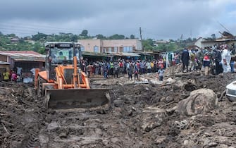An excavator digs to search for survivors after mudslide which occurred due to heavy rains resulting from cyclone Freddy at Manje informal settlement in Blantyre, southern Malawi, on March 16, 2023. - As the rains ceased for the first time in five days, Malawi began the process of recovering bodies from cyclone Freddy-induced mudslides. (Photo by Amos Gumulira / AFP) (Photo by AMOS GUMULIRA/AFP via Getty Images)