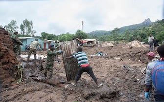 Malawi Defence Force, (MDF) soldiers work with community members to recover bodies of victims of landslides which occurred due to heavy rains resulting from cyclone Freddy during an MDF rescue operation at Manje informal settlement in Blantyre, southern Malawi on March 16, 2023. - As the rains ceased for the first time in five days, Malawi began the process of recovering bodies from cyclone Freddy-induced mudslides.
A joint operation by the military and members of the local communities recovered five bodies on March 16, 2023 from the mud. (Photo by Amos Gumulira / AFP) (Photo by AMOS GUMULIRA/AFP via Getty Images)