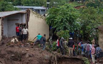 Malawi Defence Force (MDF) soldiers work with community members to recover bodies of victims of landslides which occurred due to heavy rains resulting from cyclone Freddy during an MDF search and rescue operation at Manje informal settlement in Blantyre, southern Malawi on March 16, 2023. - As the rains ceased for the first time in five days, Malawi began the process of recovering bodies from cyclone Freddy-induced mudslides.
A joint operation by the military and members of the local communities recovered five bodies on March 16, 2023 from the mud. (Photo by Amos Gumulira / AFP) (Photo by AMOS GUMULIRA/AFP via Getty Images)
