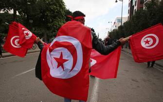 Tunisian demonstrators raise national flags and protest placards as they take to the streets of the capital Tunis, on January 14, 2023, to protest against their president. In July 2021, President Kais Saied sacked the government, froze parliament and seized far-reaching executive powers, later grabbing control of the judiciary -- moves opponents said aimed to install a new dictatorship in the birthplace of the Arab Spring uprisings.
Mohamed Hammi/Sipa Press
