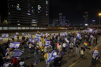 ISRAEL PROTEST epa10530880 Protesters block the Ayalon main highway during a protest march against the government's justice system reform plans in Tel Aviv, Israel, 18 March 2023. Nationwide protests against the government's judicial reform plans are being held for eleven weeks in a row. Israel's parliament passed a draft law limiting the power of the Israeli Supreme Court in a first reading on 14 March. EPA/ABIR SULTAN