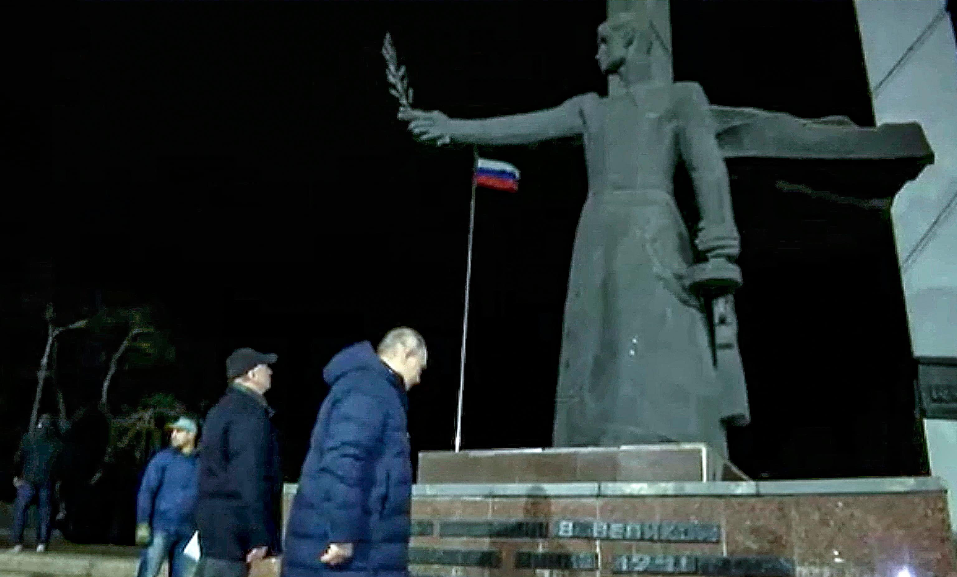 epa10532128 A still image taken from a handout video provided by the Russian President's press service on 19 March 2023 shows Russian President Vladimir Putin (R) with Deputy Prime Minister Marat Khusnullin (2-L) stand near the WWII monument during his visit to Mariupol, eastern Ukraine, late 18 March 2023. Putin visited the Russian-occupied city after he visited Crimea on the ninth anniversary of Russia's annexation of the Black Sea peninsula. According to the Kremlin, Putin had conversations with local residents, visited an apartment of one of the locals, assessed new roads, and followed the construction of new facilities in the city. On 24 February 2022 Russian troops entered the Ukrainian territory in what the Russian president declared to be a 'Special Military Operation', starting an armed conflict that has provoked destruction and a humanitarian crisis.  EPA/RUSSIAN PRESIDENT PRESS SERVICE/HANDOUT HANDOUT BEST QUALITY AVAILABLE HANDOUT EDITORIAL USE ONLY/NO SALES HANDOUT EDITORIAL USE ONLY/NO SALES