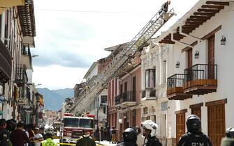 CUENCA, ECUADOR - MARCH 18: Firefighters conduct search and rescue operations after 6,8 magnitude earthquake hit the town of Balao in Ecuadorâs Azuay province on March 18, 2023 in Cuenca, Ecuador. A house collapsed onto a moving car due to the earthquake in Cuenca's historic centre. A strong earthquake struck Ecuador on Saturday, killing at least four people, according to the country's Risk Management Secretariat. (Photo by Dario Ordonez/Anadolu Agency via Getty Images)