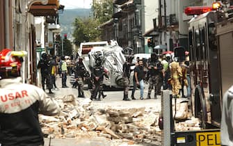 CUENCA, ECUADOR - MARCH 18: Police take security measures after 6,8 magnitude earthquake hit the town of Balao in Ecuadorâs Azuay province on March 18, 2023 in Cuenca, Ecuador. A house collapsed onto a moving car due to the earthquake in Cuenca's historic centre. A strong earthquake struck Ecuador on Saturday, killing at least four people, according to the country's Risk Management Secretariat. (Photo by Dario Ordonez/Anadolu Agency via Getty Images)