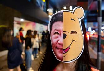 HONG KONG, CHINA - 2019/10/31: A protester wearing a Winnie the Pooh and Xi Jinping mask during the demonstration. Protesters at Halloween march in Hong Kong island despite police banned rallies and confront them during the night. (Photo by Miguel Candela/SOPA Images/LightRocket via Getty Images)