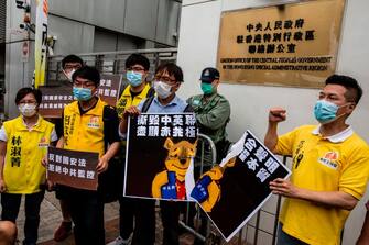 1214816929 Pro-democracy activists tear a placard of Winnie-the-pooh that represents Chinese President Xi Jinping during a protest against a proposed new security law outside the Chinese Liaison Office in Hong Kong on May 24, 2020. - The proposed legislation is expected to ban treason, subversion and sedition, and follows repeated warnings from Beijing that it will no longer tolerate dissent in Hong Kong, which was shaken by months of massive, sometimes violent anti-government protests last year. (Photo by ISAAC LAWRENCE / AFP) (Photo by ISAAC LAWRENCE/AFP via Getty Images)
