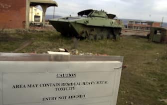 384275 02: A warning sign cautions "Area May Contain Residual Heavy Metal Toxicity, Entry Not Advised" January 12, 2001 in Klina, Kosovo at one of 112 sites where NATO used armor-piercing shells tipped with depleted uranium during the 1999 bombing of Yugoslavia .  A UN field survey of Kosovo sites attacked by depleted uranium ammunition suggests that many areas could be contaminated, prompting demands that the areas be cordoned off and local people warned to stay away.  (Photo by Darko Bandic/Newsmakers)
