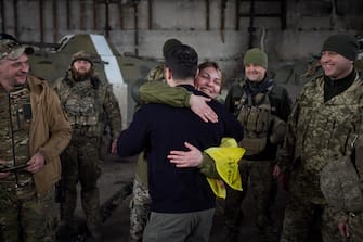 epa10536770 A handout photo made available by the Ukrainian Presidential Press Service shows Ukrainian President Volodymyr Zelensky (front) hugging a servicewoman as he visits the advanced positions of the Ukrainian military in the Bakhmut direction, during a working trip to the Donetsk region, at an undisclosed location in Ukraine, 22 March 2023, amid the Russian invasion of the country. Russian troops entered Ukrainian territory on 24 February 2022, starting a conflict that has provoked destruction and a humanitarian crisis.  EPA/PRESIDENTIAL PRESS SERVICE HANDOUT  HANDOUT EDITORIAL USE ONLY/NO SALES