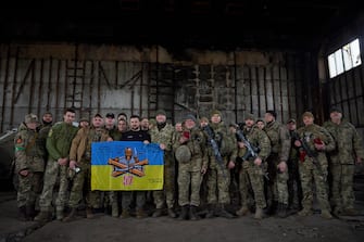 epa10536772 A handout photo made available by the Ukrainian Presidential Press Service shows Ukrainian President Volodymyr Zelensky (8-L) posing for a photo with servicemen as he visits the advanced positions of the Ukrainian military in the Bakhmut direction, during a working trip to the Donetsk region, at an undisclosed location in Ukraine, 22 March 2023, amid the Russian invasion of the country. Russian troops entered Ukrainian territory on 24 February 2022, starting a conflict that has provoked destruction and a humanitarian crisis.  EPA/PRESIDENTIAL PRESS SERVICE HANDOUT  HANDOUT EDITORIAL USE ONLY/NO SALES