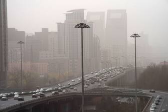 Vehicles travel on a road shrouded in smog during a sandstorm in Beijing, China, on Wednesday, March 22, 2023. Beijing warned vulnerable residents to stay indoors Wednesday, as a sandstorm  the third this month  combined with regular industrial pollution to create a thick, unbreathable haze over the city, the worst inÂ two years.Â Source: Bloomberg