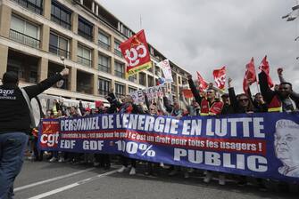 epa10538315 CGT trade union members hold a banner reading 'Energy personnel in struggle, gas and electricity are not for the private sector, they are for all users' during a rally against the government's reform to the pension system, in Marseille, France, 23 March 2023. Protests continue in France after the prime minister announced on 16 March 2023 the use of Article 49 paragraph 3 (49.3) of the French Constitution to have the text on the controversial pension reform law - raising retirement age from 62 to 64 - be definitively adopted without a vote.  EPA/GUILLAUME HORCAJUELO