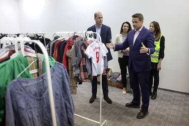 WARSAW, POLAND - MARCH 22: Prince William, Prince of Wales (L) and the Mayor of Warsaw RafaÅ Trzaskowski (second right) view donation of clothes that the centre has received and distributed via a "free shop" at an accommodation centre during their visit on March 22, 2023 in Warsaw, Poland. The centre, at the frontline of the humanitarian crisis, houses around 300 Ukrainian women and children and provides residents with two meals per day, while also offering a range of other services including Polish language lessons, a childrenâ s play area and psychological support. (Photo by Chris Jackson - Pool/Getty Images)