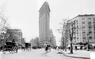 View of the Flatiron Building, New York, New York, October 1903. Horse drawn carriages, pedestrians and a street cleaner are visible.  Photo was taken during Reverend John A Dowie's trip to New York. (Photo by Chicago Sun-Times/Chicago Daily News collection/Chicago History Museum/Getty Images)