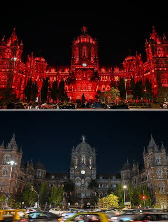 (COMBO) This combination of photographs shows the Chhatrapati Shivaji Terminus (CST) railway station illuminated before (top) and after (bottom) the lights were turned off to mark the Earth Hour environmental campaign in Mumbai on March 25, 2023. (Photo by Punit PARANJPE / AFP) (Photo by PUNIT PARANJPE/AFP via Getty Images)