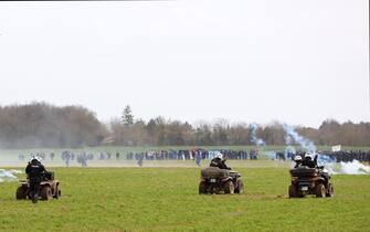 Riot mobile gendarmes use quad bikes and face protesters during a demonstration called by the collective "Bassines non merci", the environmental movement "Les Soulevements de la Terre" and the French trade union 'Confederation paysanne' to protest against the construction of a new water reserve for agricultural irrigation, in Sainte-Soline, central-western France, on March 25, 2023. - More than 3,000 police officers and gendarmes have been mobilised and 1,500 "activists" are expected to take part in the demonstration, around Sainte-Soline. The new protest against the "bassines", a symbol of tensions over access to water, is taking place under thight surveillance on March 25, 2023 in the Deux-Sevres department. (Photo by Yohan Bonnet / AFP) (Photo by YOHAN BONNET/AFP via Getty Images)