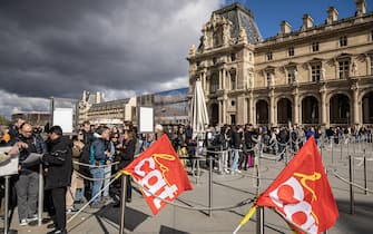 epa10545221 Visitors wait outside the Louvre Museum as its employees block entrance during a demonstration to protest against the government's pension reform in Paris, France, 27 March 2023. France faces an ongoing national strike against the government's pensions reform after Prime Minister Elisabeth Borne on 16 March announced the use of article 49 paragraph 3 (49.3) of the Constitution of France to have the text on the controversial pension reform law to be definitively adopted without a vote.  EPA/CHRISTOPHE PETIT TESSON