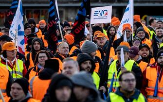 27 March 2023, Duisburg: Members of the EVG rail and transport union stand during a rally in front of the main train station in Duisburg. With a large-scale nationwide warning strike, the unions EVG and Verdi paralyzed large parts of public transport on Monday. Photo: Christoph Reichwein/dpa (Photo by Christoph Reichwein/picture alliance via Getty Images)