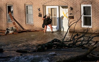 LITTLE ROCK, AR - MARCH 31: A woman evacuates from her home after a large tornado damaged hundreds of homes and buildings on March 31, 2023 in Little Rock, Arkansas.  Tornados damaged hundreds of homes and buildings Friday afternoon across a large part of Central Arkansas.  Governor Sarah Huckabee Sanders declared a state of emergency after the catastrophic storms that hit on Friday afternoon.  According to local reports, the storms killed at least three people.  (Photo by Benjamin Krain/Getty Images)