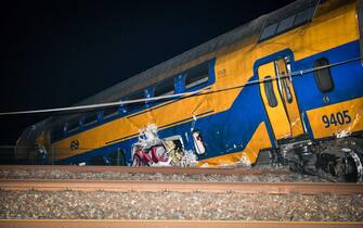 epa10557658 A view on a derailed night train in Voorschoten, The Netherlands, 04 April 2023. One person has died and several people were seriously injured after a passenger train collided with construction equipment on the tracks.  A freight train was also involved in the accident.  EPA/JOSH WALET