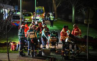epa10557659 Emergency services work at a site of a derailed night train in Voorschoten, The Netherlands, 04 April 2023. One person has died and several people were seriously injured after a passenger train collided with construction equipment on the tracks.  A freight train was also involved in the accident.  EPA/JOSH WALET