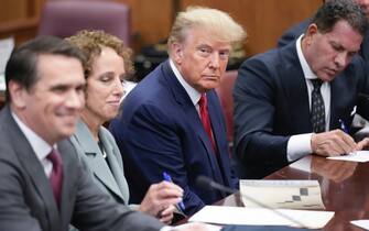 NEW YORK, NEW YORK - APRIL 04: Flanked by attorneys, former US President Donald Trump appears in the courtroom for his arraignment proceeding at Manhattan Criminal Court on April 4, 2023, in New York City.  Trump was arraigned during his first court appearance today following an indictment by a grand jury that heard evidence about money paid to adult film star Stormy Daniels before the 2016 presidential election.  With the indictment, Trump becomes the first former US president in history to be charged with a criminal offense.  (Photo by Seth Wenig-Pool/Getty Images)