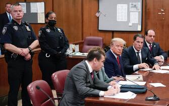 NEW YORK, NEW YORK - APRIL 04: Flanked by attorneys, former US President Donald Trump appears in the courtroom for his arraignment proceeding at Manhattan Criminal Court on April 4, 2023, in New York City.  Trump was arraigned during his first court appearance today following an indictment by a grand jury that heard evidence about money paid to adult film star Stormy Daniels before the 2016 presidential election.  With the indictment, Trump becomes the first former US president in history to be charged with a criminal offense.  (Photo by Seth Wenig-Pool/Getty Images)