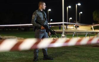 An Israeli policeman stands guard at the site of an attack in Tel Aviv on April 7, 2023. - One man was killed and four people were wounded in an attack in central Tel Aviv, Israeli rescue services said, updating a previous casualty toll of two injured.  (Photo by AHMAD GHARABLI / AFP) (Photo by AHMAD GHARABLI/AFP via Getty Images)