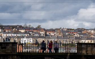 People look over the Bogside area in Londonderry, also known as Derry, Northern Ireland, UK, on ​​Monday, April 10, 2023. US President Joe Biden will visit Northern Ireland and the Republic of Ireland to coincide with the 25th anniversary of the signing of the Good Friday Agreement.  Photographer: Chris J. Ratcliffe/Bloomberg