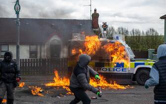 Members of the dissident republicans nationalist group throw petrol bombs at a police vehicle as they hold an anti-agreement rally on the 25th anniversary of the peace deal in Londonderry, also known as Derry, Northern Ireland, UK, on ​​Monday, April 10, 2023 US President Joe Biden will visit Northern Ireland and the Republic of Ireland to coincide with the 25th anniversary of the signing of the Good Friday Agreement.  Photographer: Chris J. Ratcliffe/Bloomberg