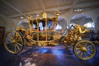 The Gold State Coach on display at the Royal Mews in Buckingham Palace, London, ahead of King Charles III's Coronation on May 6. The King and Queen Consort will travel to the coronation in the modern Diamond Jubilee State Coach and return to the historic Gold State Coach.  Picture date: Tuesday April 4, 2023. (Photo by Yui Mok/PA Images via Getty Images)