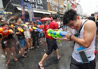 epa10570625 People take part in a water gun battle as part of the annual Songkran festival, also known as water festival, the traditional Thai New Year celebrations, at the tourist spot of Khao San Road in Bangkok, Thailand, 13 April 2023. Thailand celebrates its first water-splashing Songkran festival following a three-year pause due to the COVID-19 pandemic. Songkran is celebrated with splashing water and putting powder on each other's faces as a symbolic sign of cleansing and washing away the sins from the old year.  EPA/RUNGROJ YONGRIT