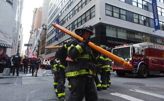 epa10579314 New York City Fire Department firefighters work the scene of a parking structure collapse in the Financial District of New York City, New York, USA, 18 April 2023. Fire Department officials have reported three injuries but advised they expect that to increase.  EPA/JUSTIN LANE