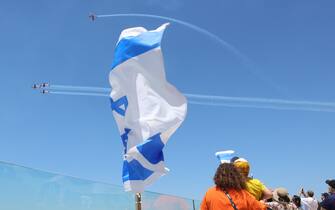 epa10591935 People watch Israeli Air Force aerobatic team performing during Independence Day air show above the beaches of Tel Aviv, Israel, 26 April 2023. Israel is celebrating the 75th Independence Day. EPA/ABIR SULTAN