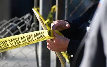 A San Mateo County Sheriff officer puts up police tape at a crime scene after a shooting at the Spanish Town shops in Half Moon Bay, California, on January 24, 2023. - A suspected gunman was in custody Monday over the killing of seven people in a rural community in northern California, just two days after a mass shooting at a Lunar New Year celebration near Los Angeles. (Photo by Samantha Laurey / AFP) (Photo by SAMANTHA LAUREY/AFP via Getty Images)