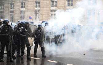 French gendarmes face off with protesters in a cloud of teargas during a demonstration on May Day (Labour Day), to mark the international day of the workers, more than a month after the government pushed an unpopular pensions reform act through parliament, in Paris, on May 1, 2023. - Opposition parties and trade unions have urged protesters to maintain their three-month campaign against the law that will hike the retirement age to 64 from 62. (Photo by Alain JOCARD / AFP) (Photo by ALAIN JOCARD/AFP via Getty Images)