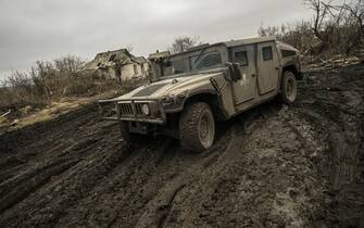 A Ukrainian armored vehicle drives on a muddy road near Bakhmut in the Donbas region, on March 9, 2023. - After a cold and snowy winter, the arrival of spring with rain and milder temperatures has brought back the mud on the Donbas battle fields.  Trenches that have become baths where soldiers wade through and trucks, armored cars and sometimes tanks destroyed after getting stuck in mud.  (Photo by Aris Messinis / AFP) (Photo by ARIS MESSINIS/AFP via Getty Images)