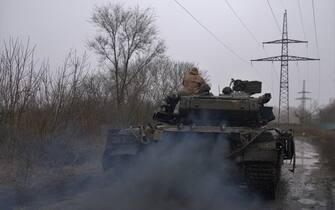 A Ukrainian T-64 tank rolls along a muddy lane from the town of Chasiv Yar, Donetsk region to Bakhmut on March 9, 2023. (Photo by Sergey SHESTAK / AFP) (Photo by SERGEY SHESTAK/AFP via Getty Images)