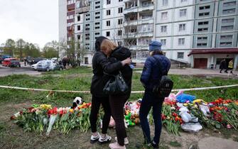 UMAN, CHERKASY OBLAST, UKRAINE - APRIL 30: People mourn in front of the flowers and toys brought by local residents in memory of the civilians who died as a result of a Russian airstrike at the strike site in the town of Uman, Cherkasy Oblast, Ukraine on April 30, 2023. (Photo by Oleksii Chumachenko/Anadolu Agency via Getty Images)