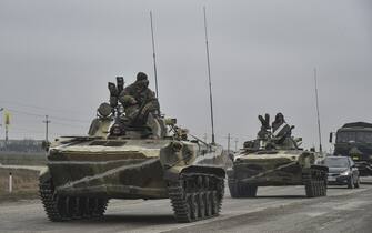 epa09784384 Russian soldiers on the amphibious infantry fighting vehicle BMP-2 move towards mainland Ukraine on the road near Armiansk, Crimea, 25 February 2022. Russian troops entered Ukraine on 24 February prompting the country's president to declare martial law and triggering a series of announcements by Western countries to impose severe economic sanctions on Russia.  EPA/STRINGER