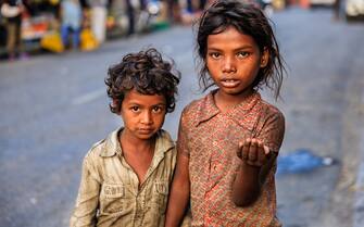 Poor Indian children asking for support.  Many Indian children suffer from poverty - more than 50% of India's total population lives below the poverty line, and more than 40% of this population are children.