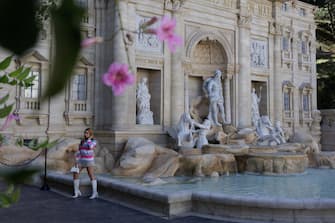 epa10634880 A tourist poses at the replica of the iconic Fontana di Trevi, built to honor Italian immigrants and boost tourism, in the city of Serra Negra, Brazil, 17 May 2023. The Serra Negra Fountain occupies an area of 370 square meters and is 11 meters high, from the water mirror, and 20.7 meters wide.  EPA/ISAAC FONTANA
