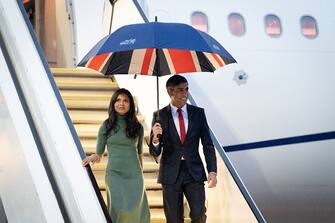 Britain's Prime Minister Rishi Sunak (R) and his wife Akshata Murty arrive in Hiroshima after their visit to Tokyo, ahead of the G7 Summit on May 18, 2023. (Photo by Stefan Rousseau / POOL / AFP) (Photo by STEFAN ROUSSEAU/POOL /AFP via Getty Images)